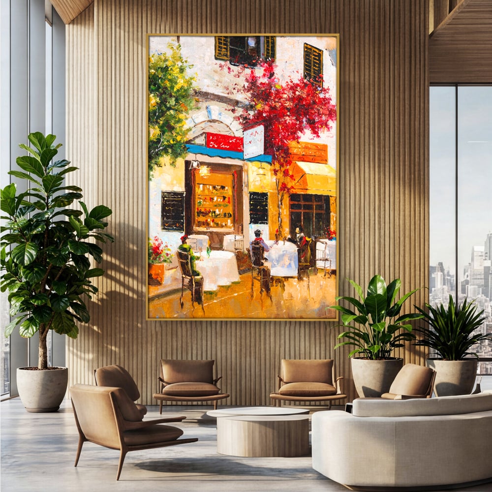 Tablou canvas cu pictura stradala cu terasa, in rama de aluminiu auriu, pe perete intr-un birou